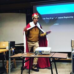 Sumeet dressed up in a crown and cape, introducing the speaker for a graduate student work in progress talk on the day after Halloween!
